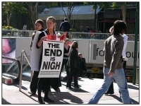 Girl with sandwich board, proclaiming The End is Nigh